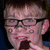 Pixelated image of a person with glasses holding a microphone, split into four quadrants with text on blue and gray backgrounds.