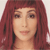 Pixelated portrait of a person with long reddish-brown hair, neutral expression, and light skin tone against a plain background.