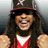 A pixelated image of a person wearing a red and white sleeveless top, dark sunglasses, and a black baseball cap with a red brim standing next to large text reading "LIL JON" in stylized lettering.