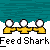 Pixelated cartoon figures in yellow shirts stand on gray ground against teal water, with text "Feed Shark" repeated below each