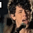 six shows a person with dark curly hair holding a microphone, with text and heart symbols changing across frames