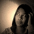 A person with long dark hair holds their hand near their head in a sepia-toned image, showing subtle facial expression changes across frames.