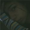 A person rests their head on a striped pillow with visible eyes and a tear-like mark on their face, shown in four with varying color tones