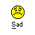Static pixel art icon featuring a yellow circular emoji face with downturned mouth and furrowed brows above the word "Sad" in blocky text on gray background.