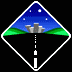Pixelated diamond-shaped scene with blue sky, green hills, city skyline, and road, showing animated rock movement on the road.