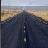 A static image shows a long, straight road stretching toward the horizon under a clear sky, with red text reading "Im On The Highway To Hell..." on a black background.