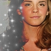 A static image of a person with long brown hair and dark hair strands, wearing a dark top with white sparkles, against a light background.