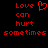 Red pixelated text on black background reads 'Love can hurt sometimes' with a heart symbol replacing the letter O in Love.
