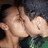 Two people kissing with pixelated faces, one person has dark hair and the other light brown hair, text reads "CuTe SHiT" on a maroon background.