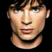 Nine distinct portrait views of a young man with dark hair, varying in expression and background across the