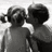 Black-and-white photo of two children kissing on a bright background, with blue text reading "When you're in love" and "your eyelashes move really fast" on cyan.