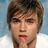 Pixelated image of a person with brown hair and a white shirt, next to blue background with white text reading jesse mccartney.