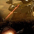 Static pixelated image of a glowing orange-yellow object against a brownish background with dark lower section.