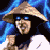 Pixelated character in conical straw hat with blue hair, dark clothing, and white accents against a green background with bright green text.