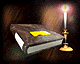 A book with a yellow bookmark rests on a dark surface next to a lit candle in a brass holder.