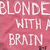 Static 50x50 pixel buddy icon with pink background and white text reading "BLONDE WITH A BRNIN" in three lines, showing visible pixelation and dithering effects.