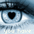 A close-up of a blue-eyed human eye with a black heart-shaped pupil, featuring pixelated text below the eye.