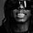 Pixelated grayscale image of a person with long dark hair, wearing large white headphones and holding a microphone close to their mouth.