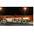 Animated sequence of a vintage car driving past streetlights on a dark road with red and yellow background elements.