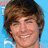 Pixelated image of a smiling person with brown hair on left, blue background on right with white pixelated text reading "I LOVE ZAC EFRON".