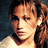 Pixelated image of a person with long brown hair wearing a light-colored top, next to orange text reading 'who's ther' on dark green background.