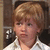 A child with light brown hair and a white collared shirt appears in four with subtle facial expression changes