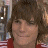 A pixelated image shows a person with brown hair and red-and-white striped clothing on the left, next to green text reading 'OriginalIcons.com' on a dark background.