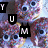 Pixelated cartoon cookies with large eyes and colorful sprinkles, arranged in a pattern with 'YUM' text blocks