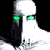 Pixelated figure with white upper body, dark lower section, and green rectangular eye-like shapes against black background.
