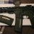 Static image of a dark-colored firearm with visible barrel and trigger guard, positioned horizontally against light background panels.
