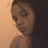 Pixelated close-up of a person with dark hair and light skin, wearing a thin-strapped top against a gradient background.