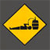 Yellow diamond-shaped warning sign with black border and black graphic of a vehicle on a road, set against dark gray background.