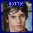 A pixelated image of a person with dark hair and light skin, wearing a blue background with 'HOTTIE' text above the head.