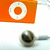 A static image shows an orange square with a white circular target-like design and a dark metallic object resembling a camera lens on a light background.