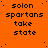 Orange background with repeated black text 'solon spartans take state' in pixelated font, scattered blue dots, and a solid gray rectangle in the bottom-right corner.