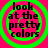 Four identical circular frames with green concentric rings on a bright pink background, each containing black text reading 'look at the pretty colors' in a pixelated font.