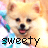 Pixelated image of a light brown dog with dark eyes and nose, mouth open showing pink tongue, wearing teal collar against blurred pastel background.