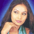 Static pixelated image of a woman with long dark hair wearing a teal top against a blue gradient background, rendered in low-resolution 50x50 pixels with visible dithering and color blending.