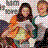 Pixelated static image of a person with long dark hair wearing an orange and white garment against a checkered background.