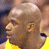 Two side-by-side images of a bald man in a yellow jersey with blue trim, one showing profile view left and the other right.