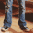 A pixelated animation showing a person in blue jeans and a gray shirt standing on a wooden floor with brown furniture in the background.