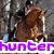 A pixelated image shows a horse jumping over an obstacle with two riders, overlaid by text reading 'hunterjumper' and 'lover'.
