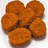 Six golden-brown fried chicken nuggets arranged in a cluster on white background with pixelated text elements above and below.
