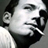 Pixelated grayscale close-up of a person's face with visible facial features and hair, displayed as a static buddy icon.
