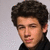 A person with dark curly hair and a black top appears in three showing subtle facial expression changes against a light gray background