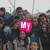 Group of people in a crowd with overlaid text elements in pink, green, and cyan colors.