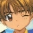 Anime-style character with brown hair and one eye open, wearing a blue shirt with yellow accents, winking at the viewer.