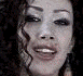 five showing sequential facial expressions from a single person with curly brown hair, transitioning through smiling and laughing poses