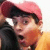 A pixelated image of a person wearing a red cap and orange shirt, with text reading THE KING HIMSELF on the right side.