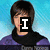 A pixelated image of a person with short dark hair wearing a purple top and black scarf against a blue background, with text overlays changing across frames.